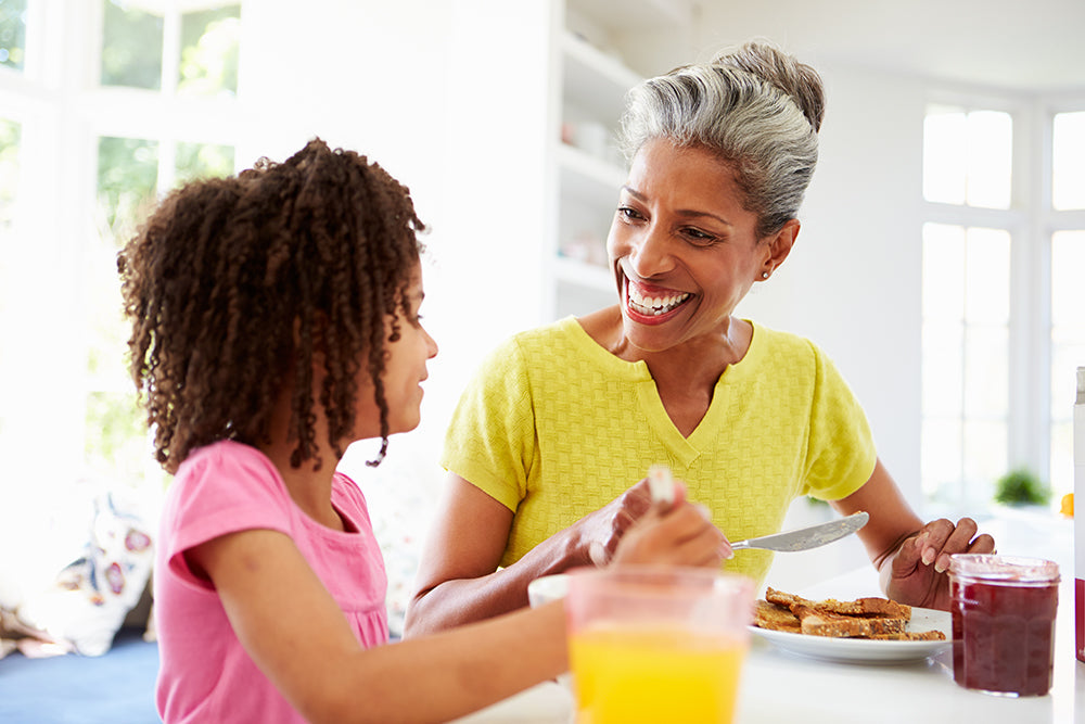 Hormonal Eczema | older woman eating with her granddaughter. 
